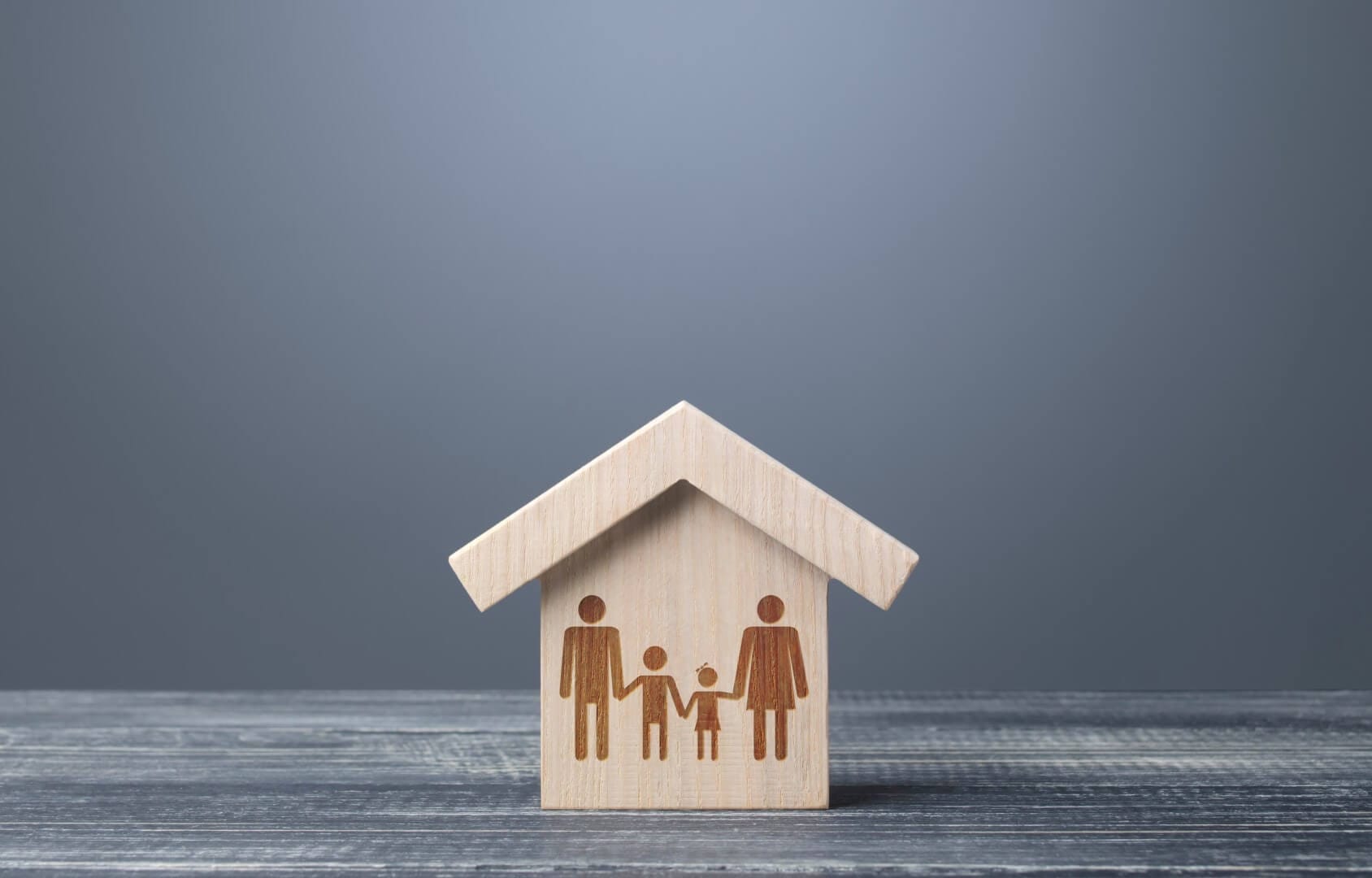 Wooden house with family icon, representing home inspection services by Fully licensed and insured Home Inspectors in Bergen County, NJ. Owned by Herman Andrade, Saddle Brook, NJ.